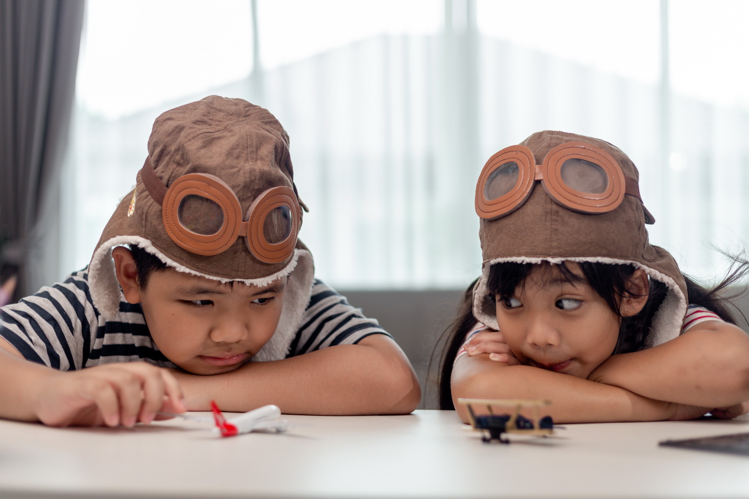 two children with airplanes in hands