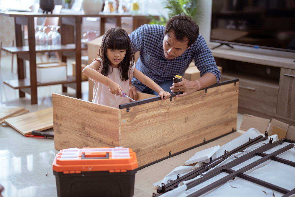 father and daughter fixing table