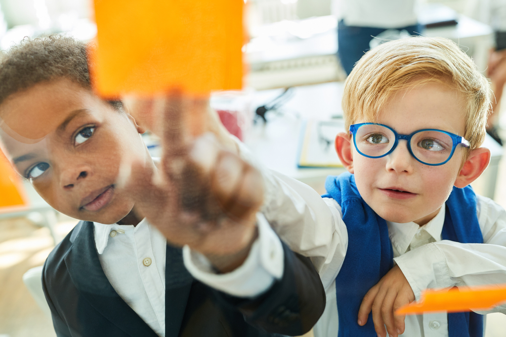 two boys placing a sticker