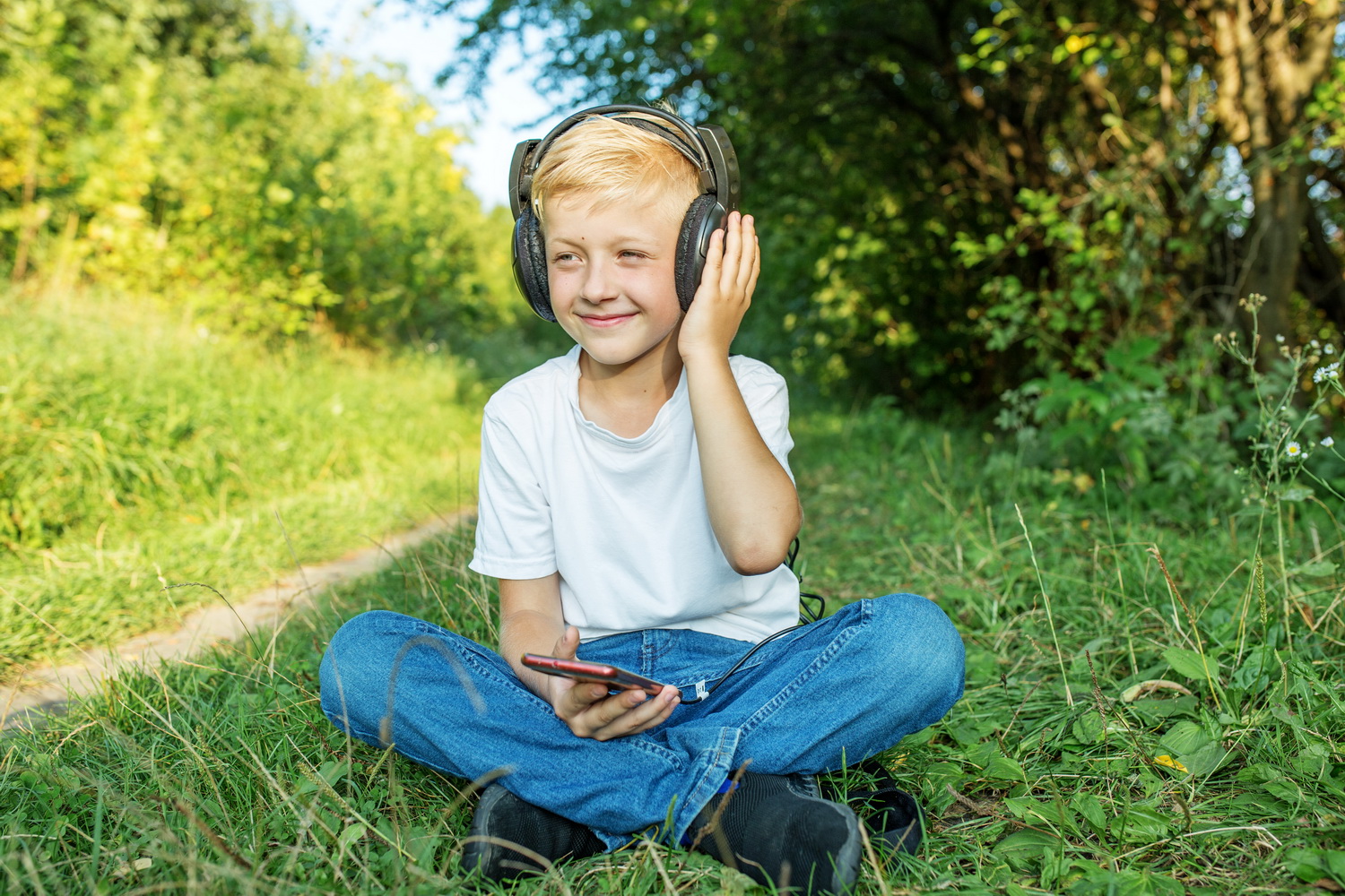 photo of boy listening to a podcast in headphones