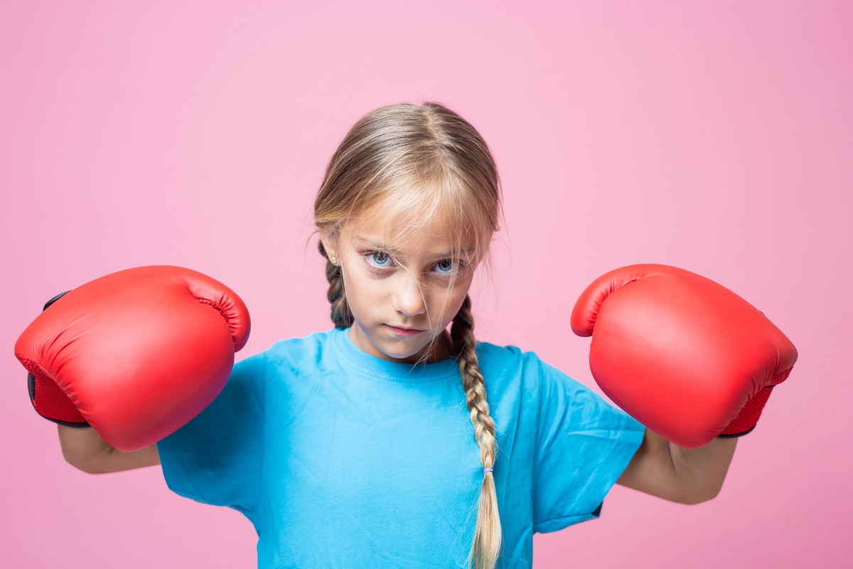 serious little girl with boxing gloves 2026 01 07 00 34 57 utc