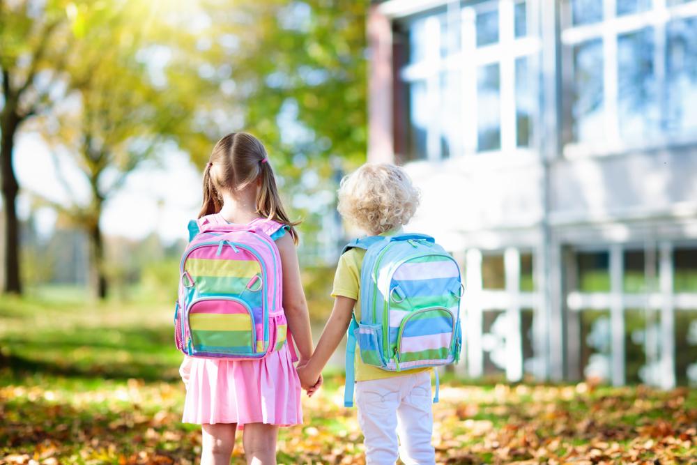 a boy and a girl holding by hands