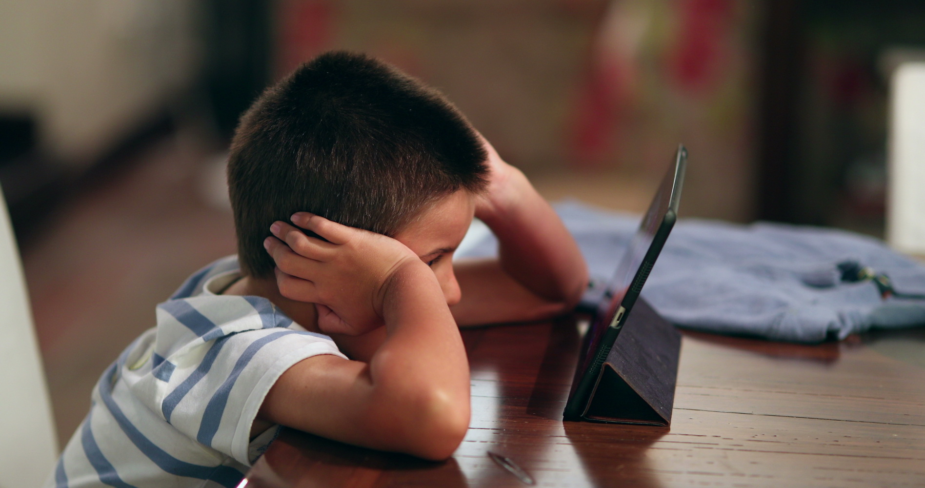 child staring at tablet