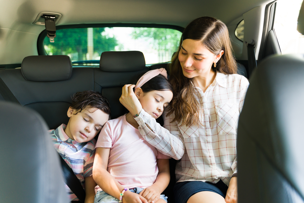 tired kid sleeps in car