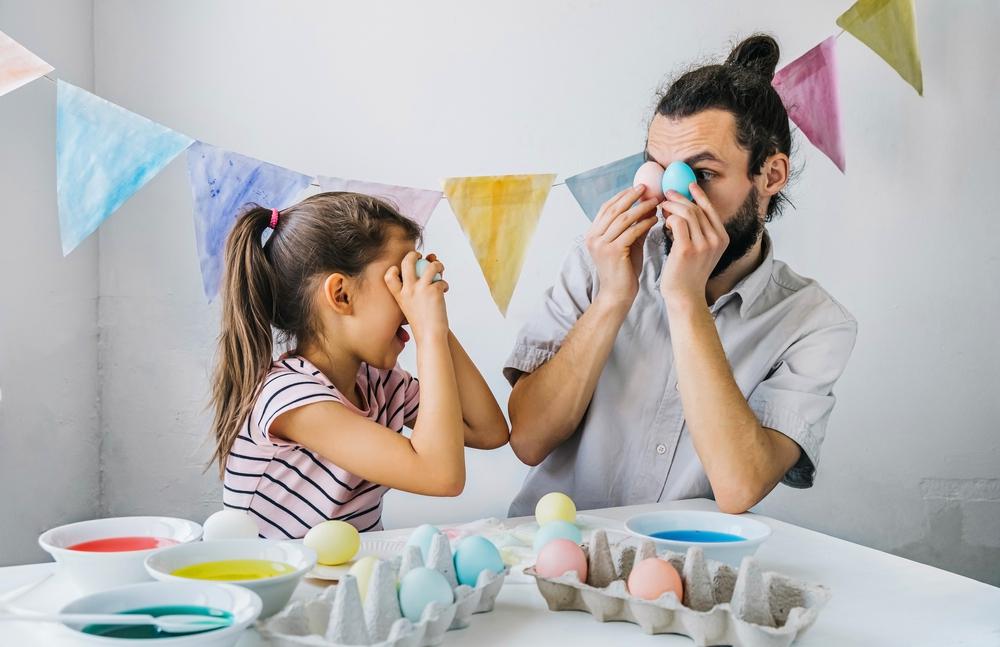 father and daughter holding eggs