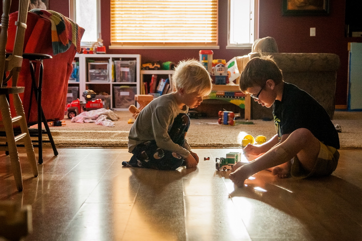 siblings playing on the floor 