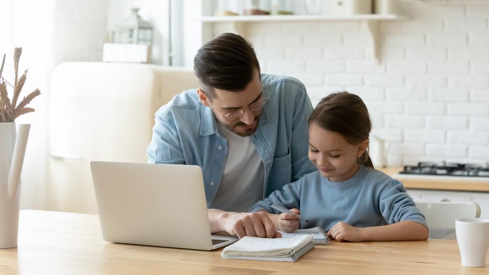 father teaching a daughter writing