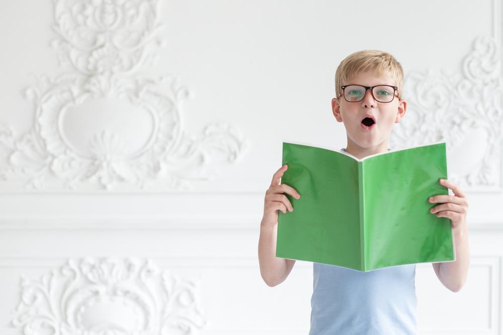 a boy is reading aloud