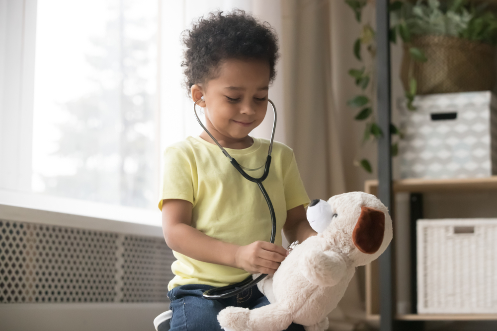 little girl playing with a bear