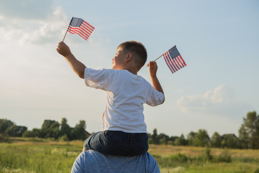 a boy with american flags
