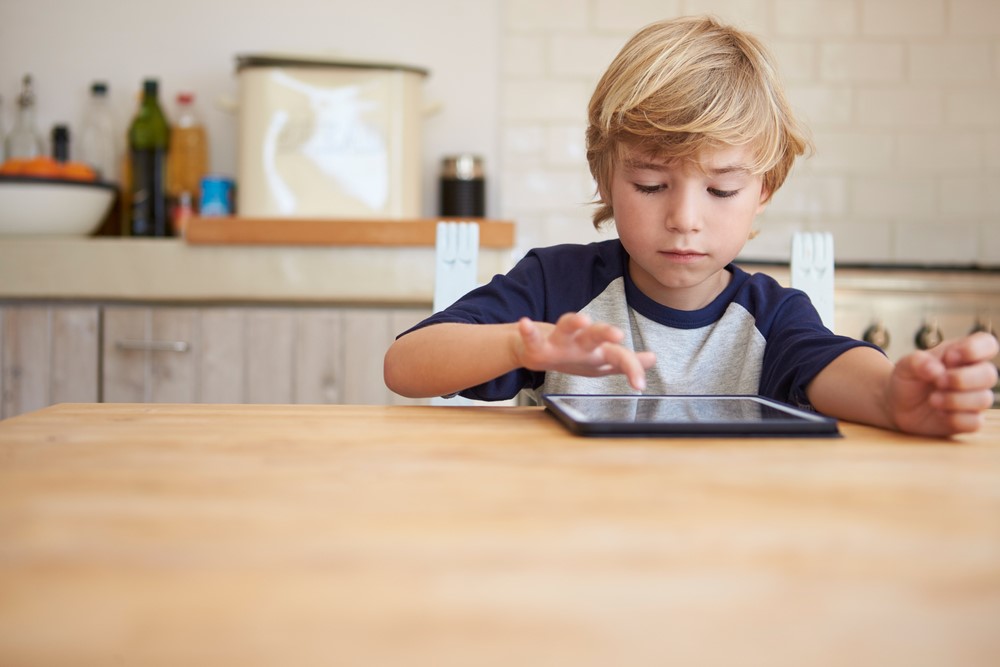 boy is using a tablet