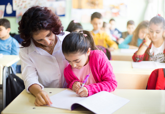 a girl with a teacher at classroom