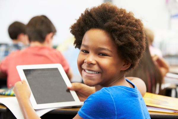 a boy with ipad at classroom