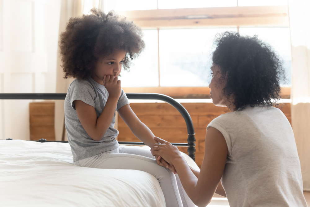 a kid sitting on a bed