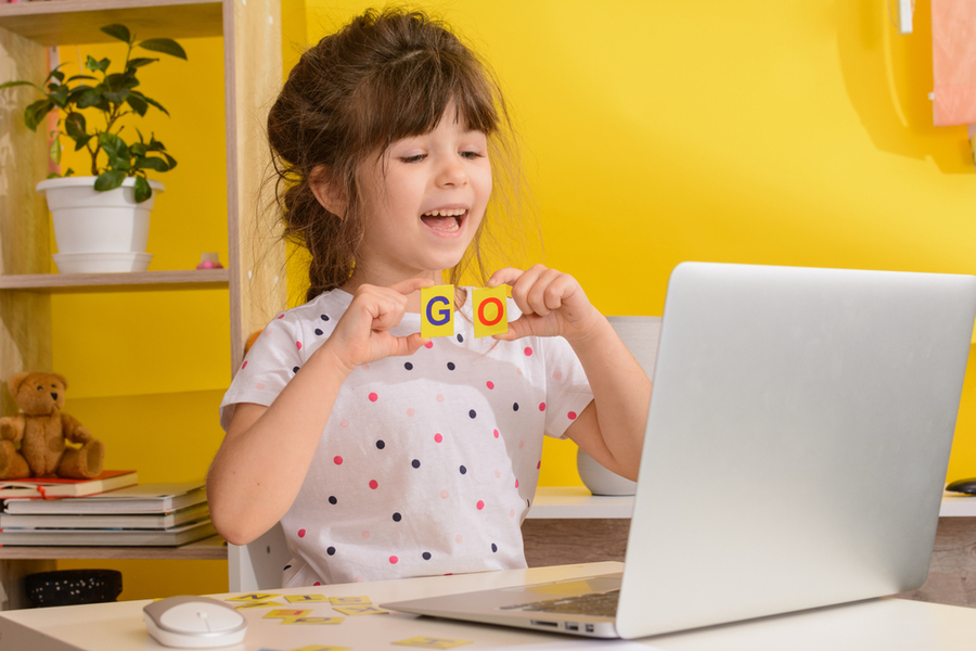 a kid is talking online through laptop