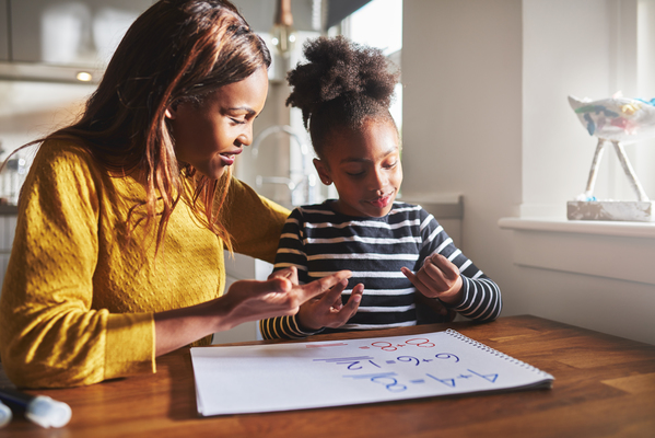 a girl with a teacher calculating