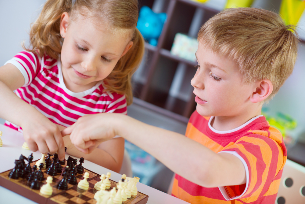 boy and girl playing chess