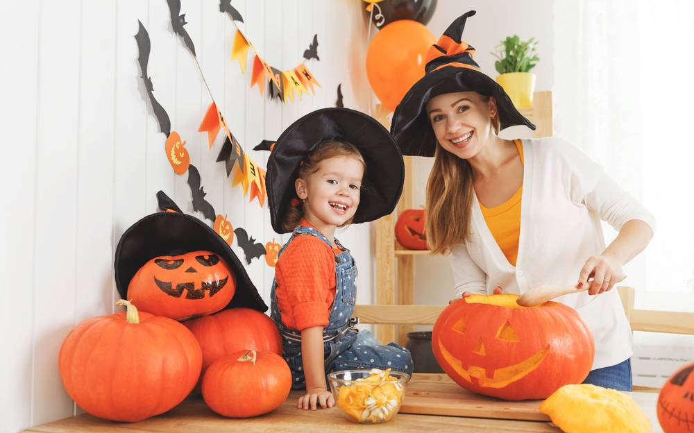 mom and daughter with pumpkins