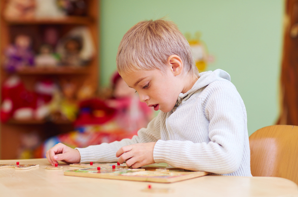 a boy with autism playing