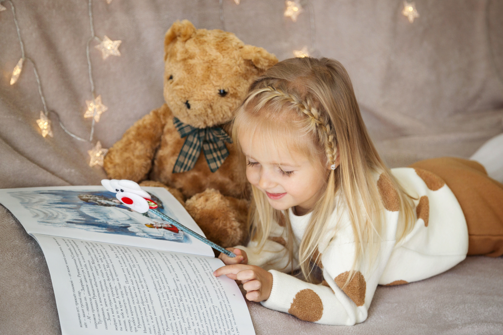 a little girl reading a book