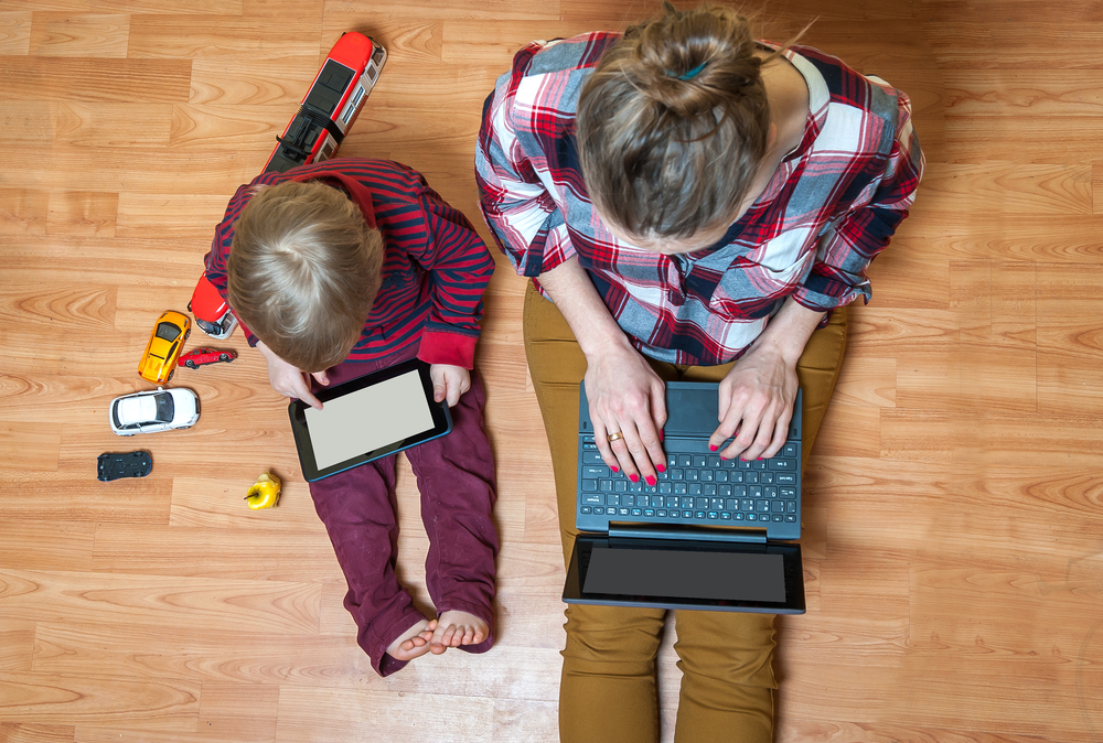 a kid with a laptop and mom