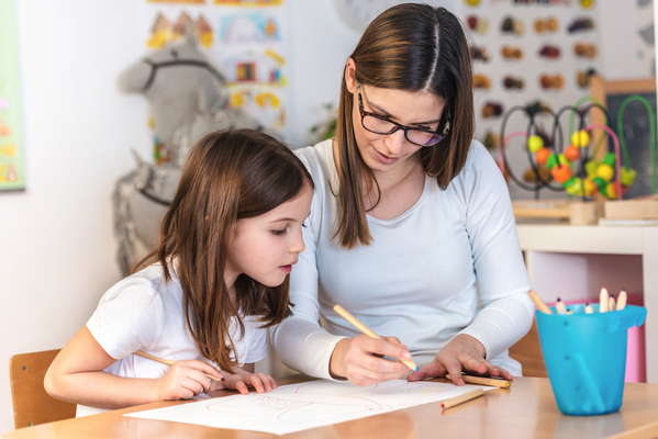 a girl and a teacher in classroom