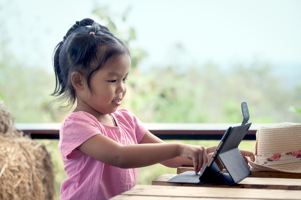 Child, tablet, outdoors