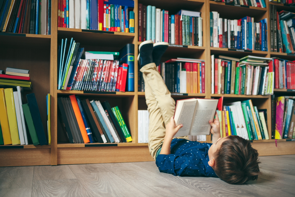 a boy on the floor with a book