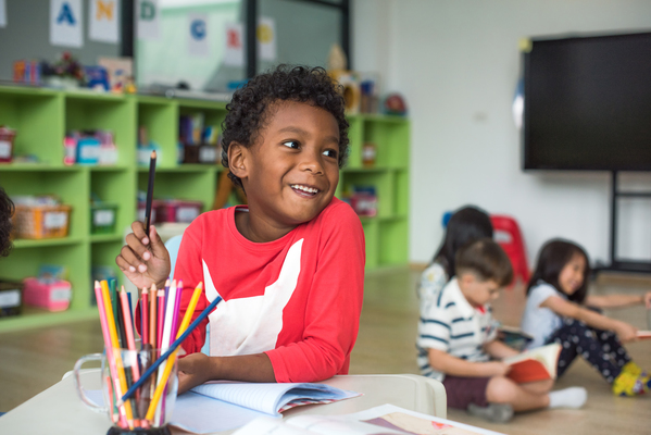 a boy sitting at the desk in classroom