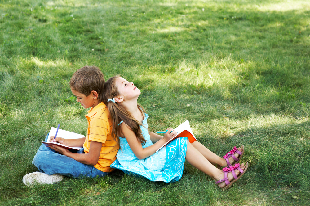 a boy and a girl writing