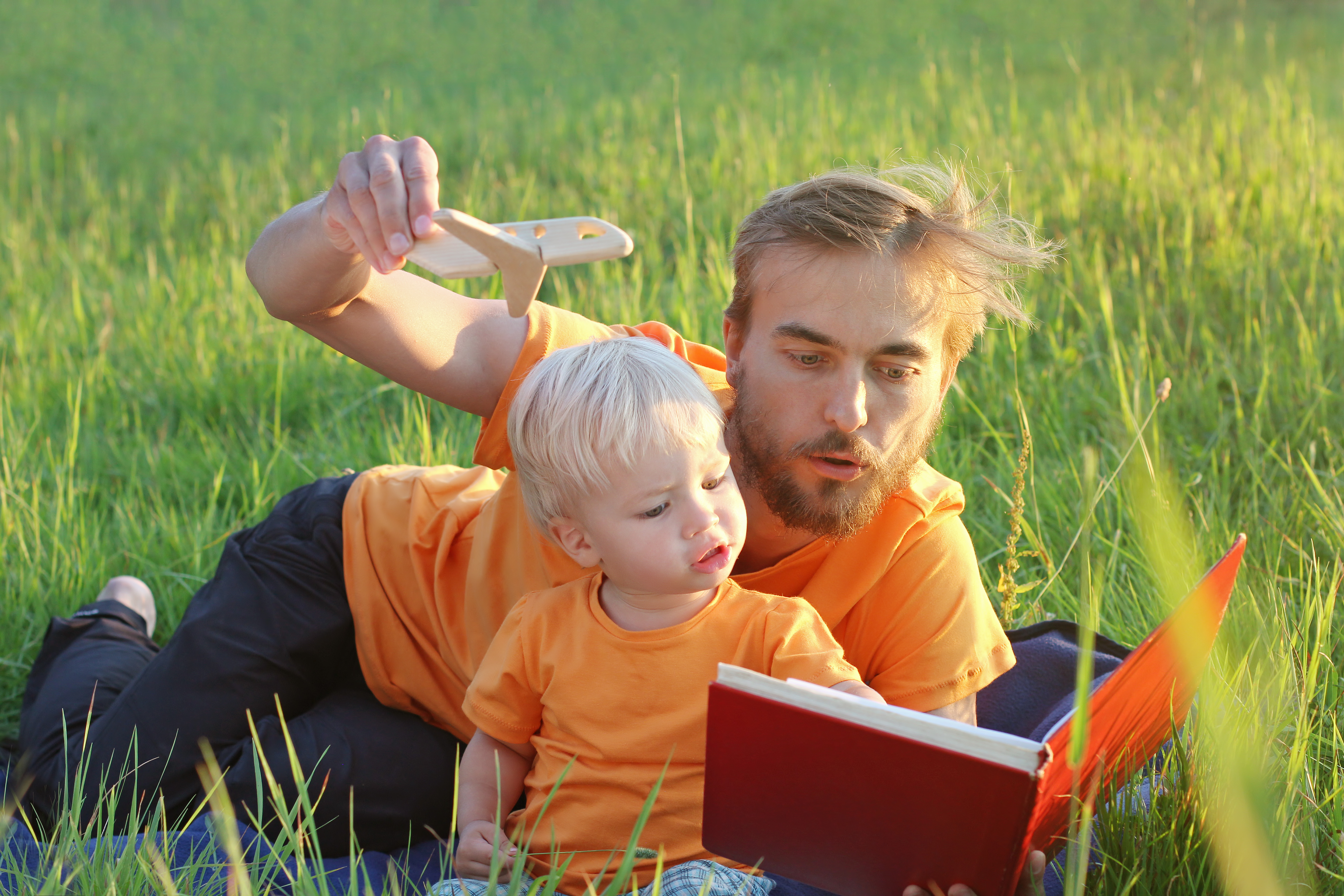 dad with son read book