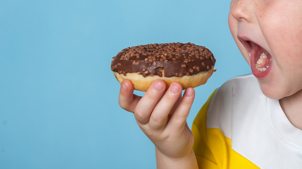 a boy eating a donut