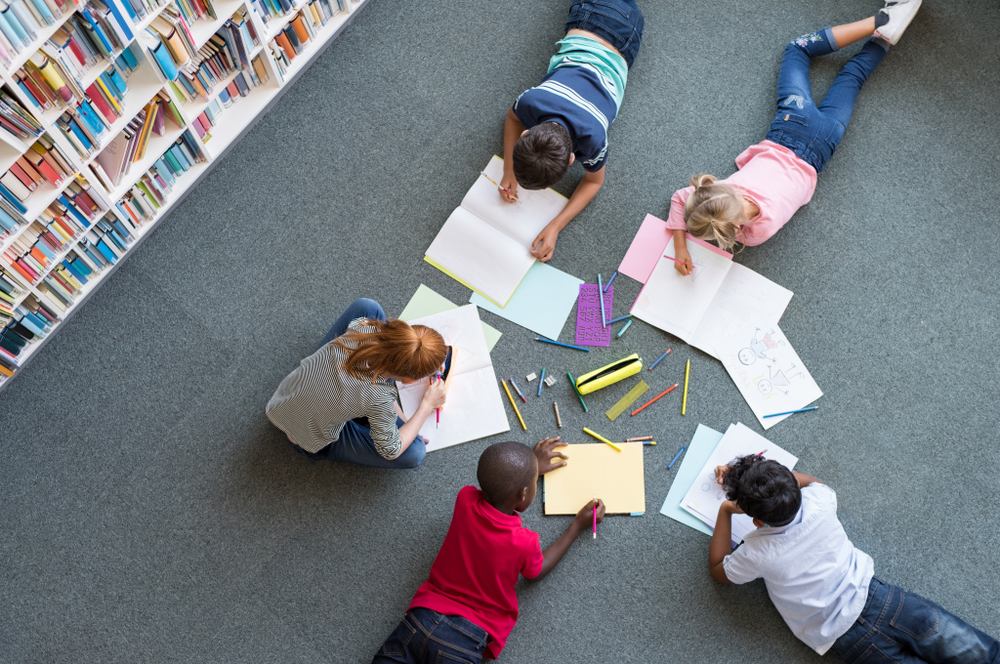 kids writing on the floor